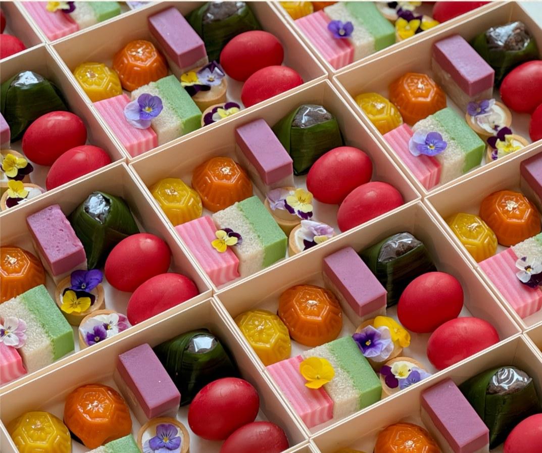 Luna's Bento Gift Set filled with colourful Nyonya kuih, angku kuih, lemon white chocolate tarts and red eggs in butterfly bento packaging.